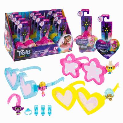 Display of Trolls toys with packaging and accessories on a white background
