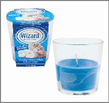 Blue candle in a glass holder next to a container labeled 'Wizard'.