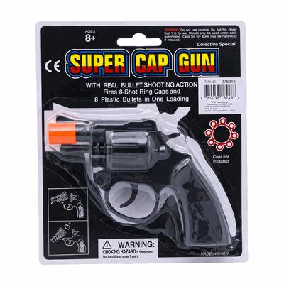 Super Cap Gun packaging with toy gun and warning label on a white background
