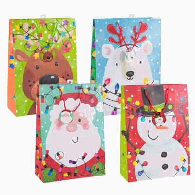 Set of four colorful gift bags with Christmas-themed designs on a white background.