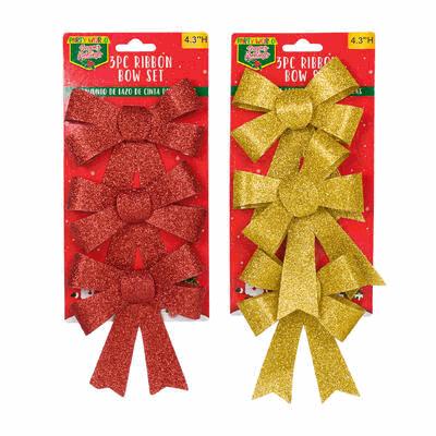 Two packages of red and gold glittery bows on a white background