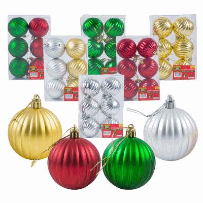 Assorted Christmas ornaments including red, green, gold, and silver balls on a white background.