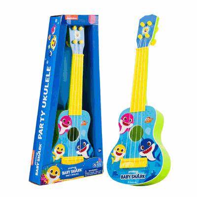 Toy ukulele with 'Baby Shark' design next to its packaging on a white background