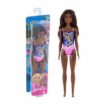 Barbie doll with swimsuit next to its packaging on a white background